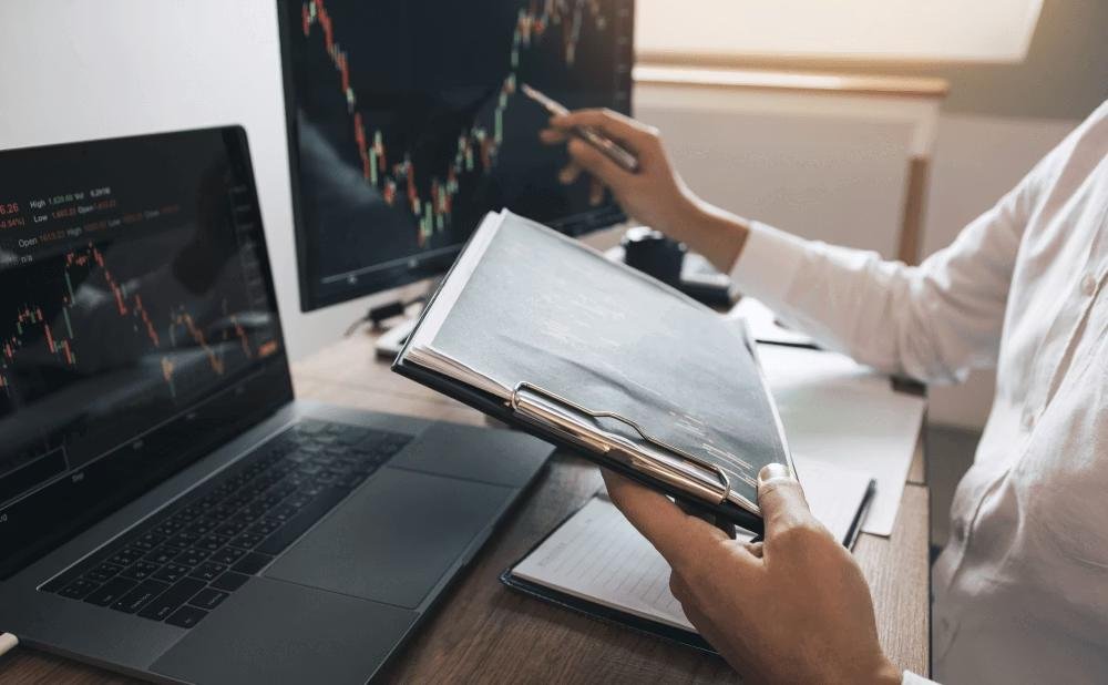 Professional Forex backtesting setup showing a trader analyzing historical TradingView-style charts, recording trades in a trading journal, and reviewing buy entry, stop loss, take profit, and backtesting results.